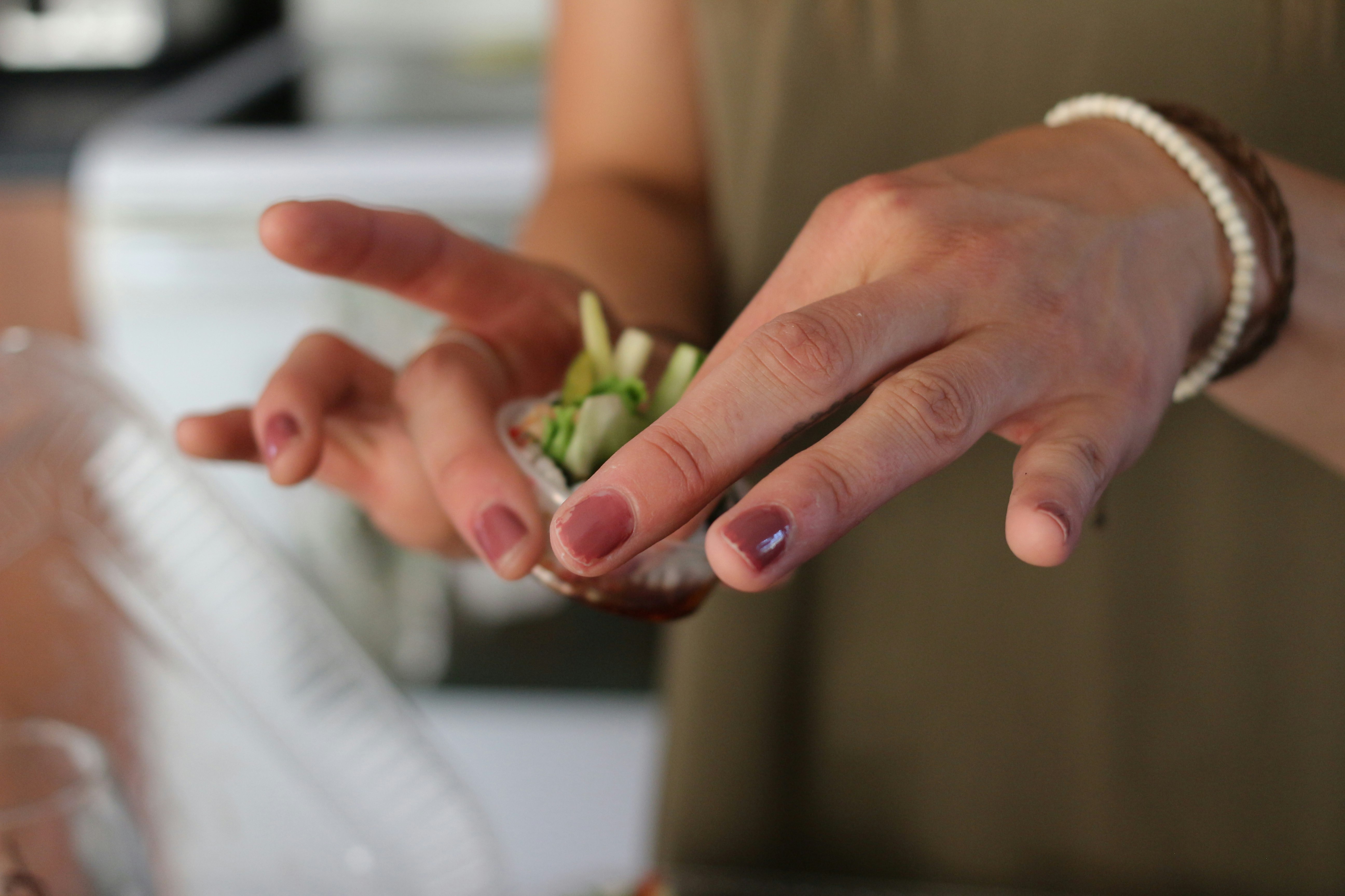 person holding green leaves on hand